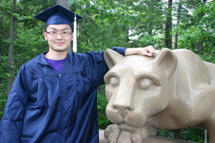 Mengye Chen in cap and gown with the Penn State Nittany Lion statue