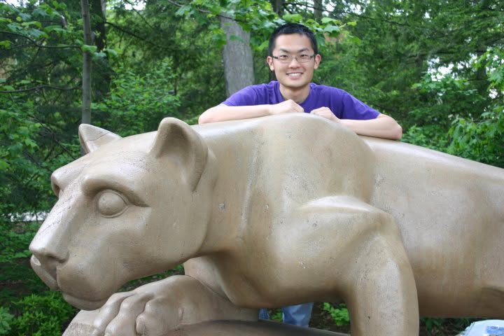 Mengye Chen leaning on the Nittany Lion statue at Penn State