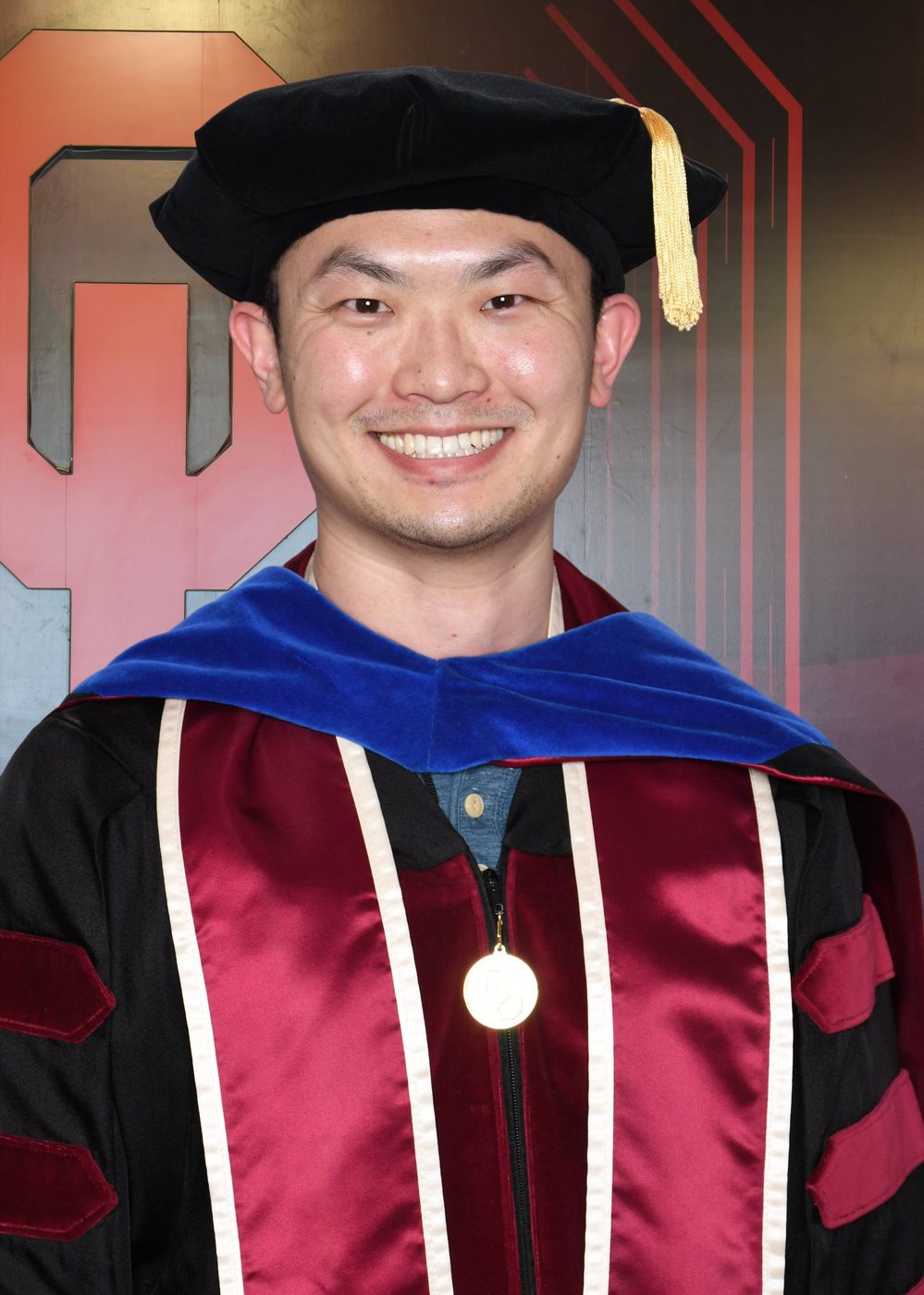 Mengye Chen in doctoral cap and gown